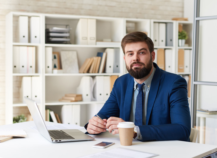 Engineer working at an office workstation monitoring a client website