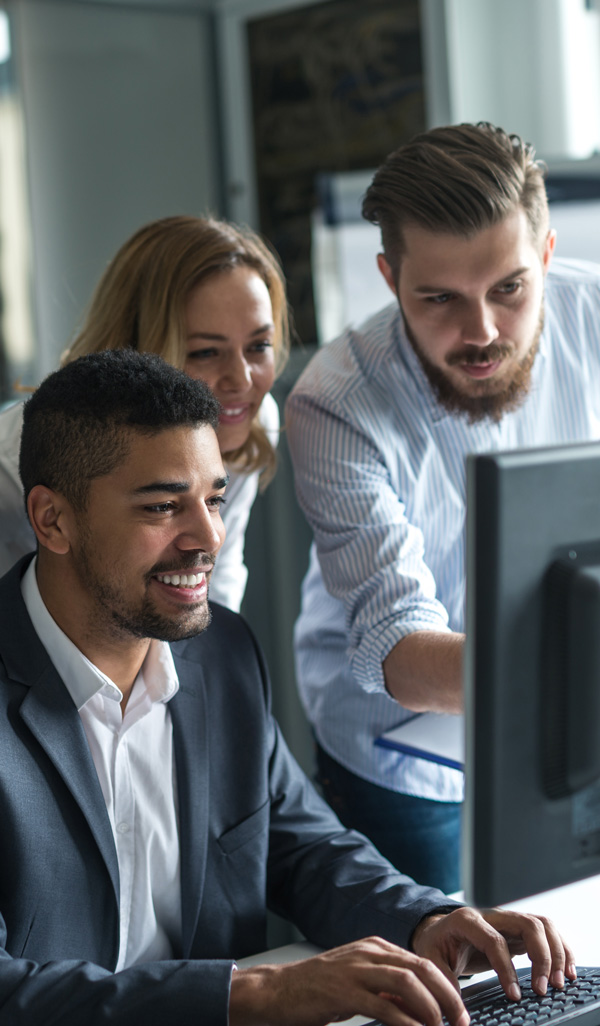 Nexza Solutions developers reviewing a client website on a monitor